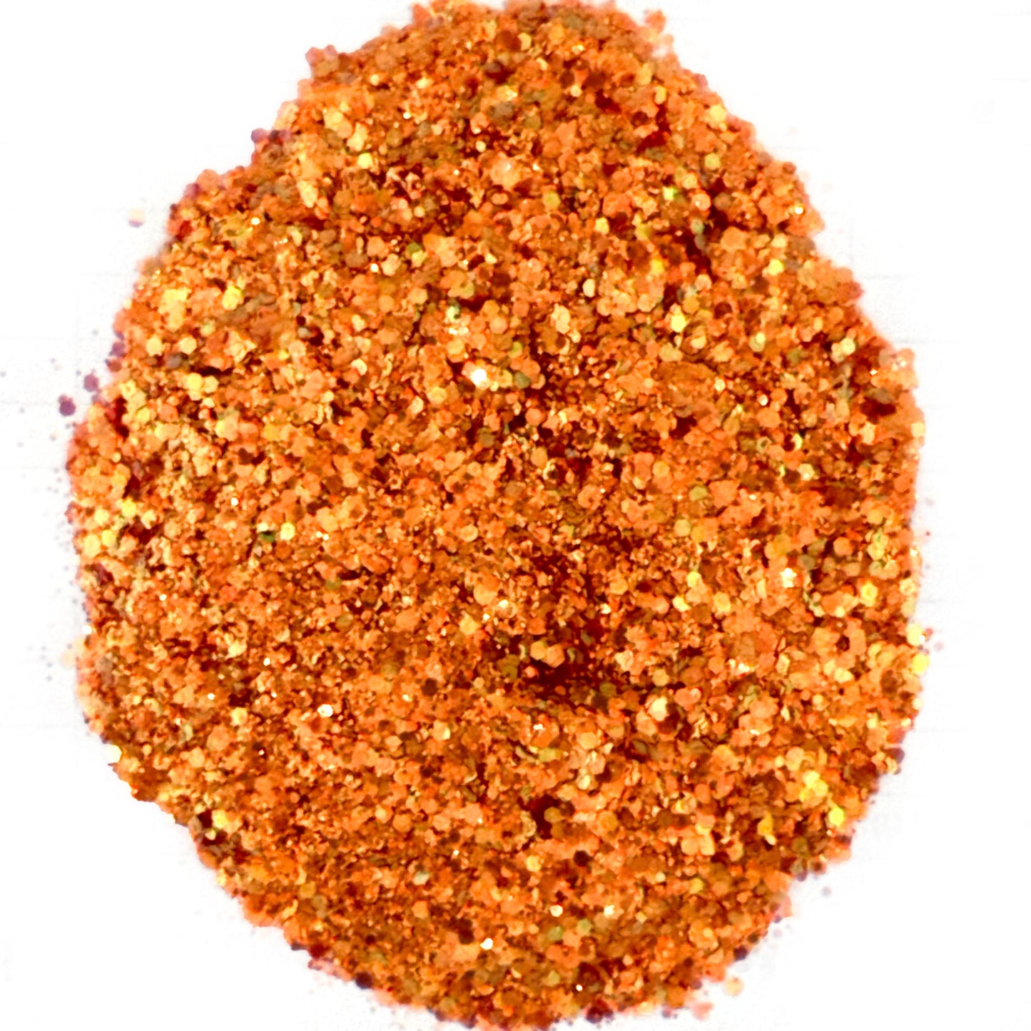Close-up of orange glitter on a white background